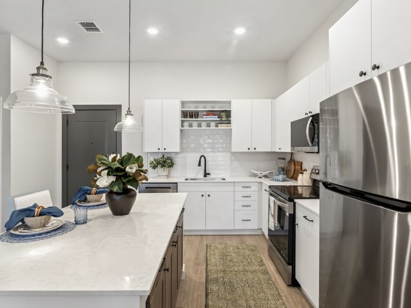 Fully Equipped Kitchen with White Cabinetry and Stainless Steel Appliances at Marisol Apartments in Port Charlotte FL