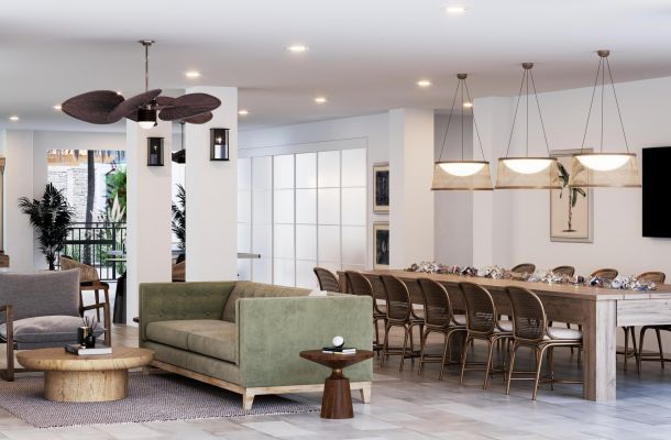 Modern open-concept living and dining area with green sofa, wood furniture, and large dining table.