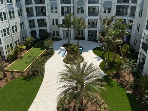 Landscaped courtyard with palm trees at Marisol luxury apartments in Port Charlotte, FL