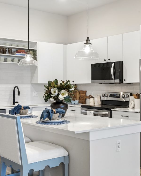 Fully Equipped Kitchen with White Cabinetry and Stainless Steel Appliances at Marisol Apartments in Port Charlotte FL