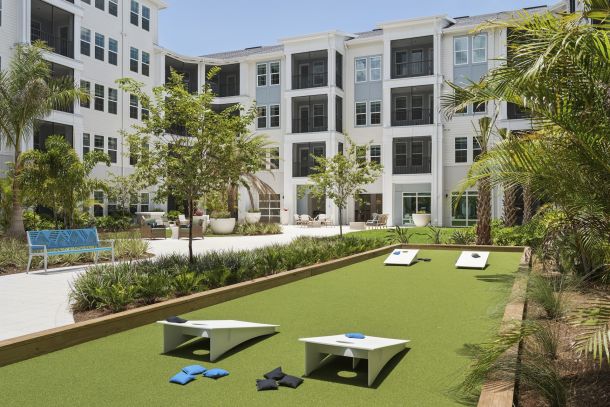 Courtyard with cornhole at Marisol Apartments in Port Charlotte FL