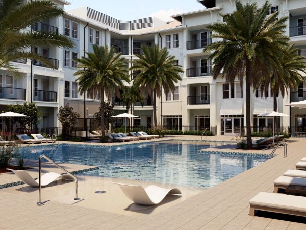 Resort-style pool courtyard with palm trees at Marisol Apartments in Port Charlotte, FL