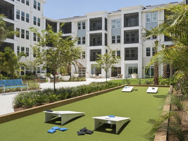 Courtyard with cornhole at Marisol Apartments in Port Charlotte FL